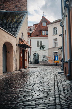 Cobbled old town street surrounded by houses in Tallinn, Estoniaの写真素材