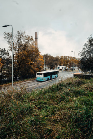 Bus driving through Tallinn, Estonia by grass bank outside the old town