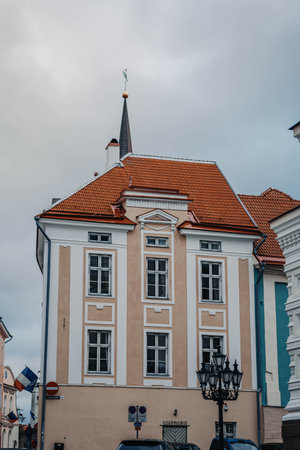 Building with church spire and Orthodox cross above behind it, Tallinn, Estoniaの写真素材