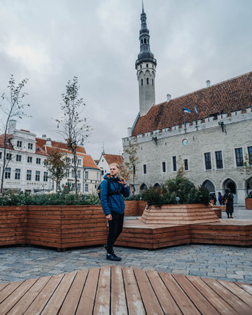 Man stood in the square in front of the city hall in Tallinn, Estoniaの写真素材