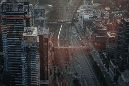 Train on tracks leaving station in Toronto, Ontario, aerial shot from CN Towerの写真素材