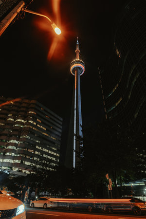 Long exposure of cars under the CN Tower at night in Toronto, Ontarioの写真素材