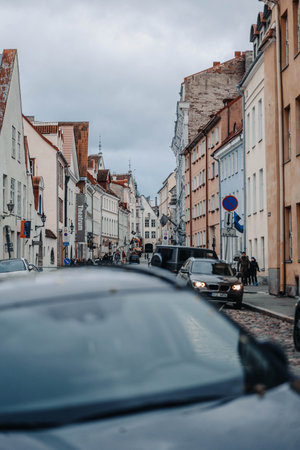 Cars parked on street in the old town in Tallinn, Estonia in autumn, cloudy day