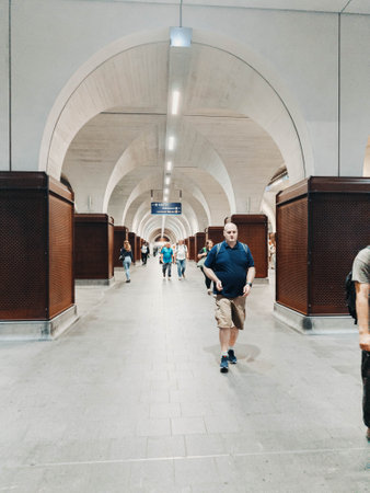 Passengers walking through bright white underground station in London, the UKの写真素材