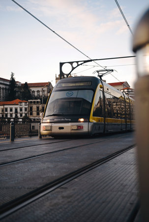 Porto metro going over Ponte Dom Luis I at sunset in Porto, Portugalの写真素材