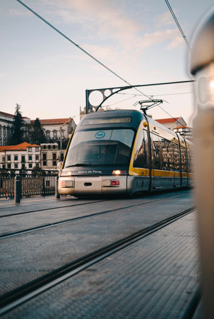 Metro train at sunset on the bridge in Porto, Portugalの写真素材