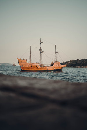 Old wooden pirate ship on the sea outside Dubrovnik old town, Croatiaの写真素材