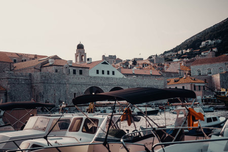 Boats at sunset in Dubrovnik old town port, Croatiaの写真素材