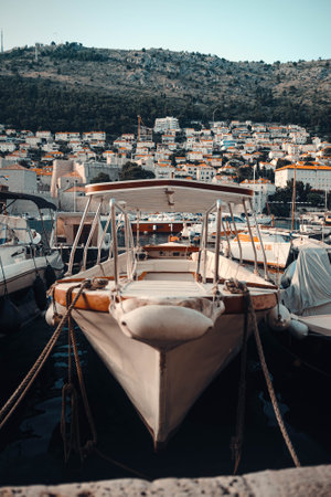 Tour boat moored in Dubrovnik old town port, Croatiaの写真素材
