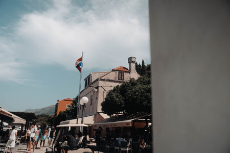 Croatian flag above old house in small town near Dubrovnik in summerの写真素材
