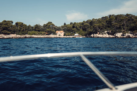 Landscape shot of house on island in the sea outside Croatia, summerの写真素材