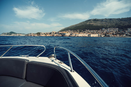 Landscape view across the sea to Dubrovnik, Croatia from boat on sea in summerの写真素材