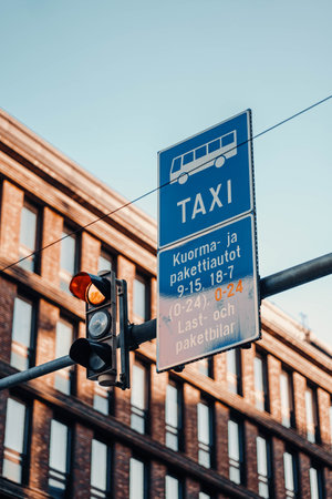 Taxi sign next to traffic lights on sunny autumn day in Helsinki, Finlandの写真素材