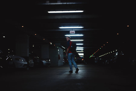 Man in underground car park looking back at cameraの写真素材