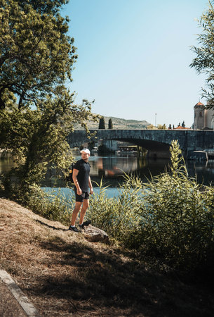 Man stood by the Tresbisnjica River in Trebinje, Bosniaの写真素材