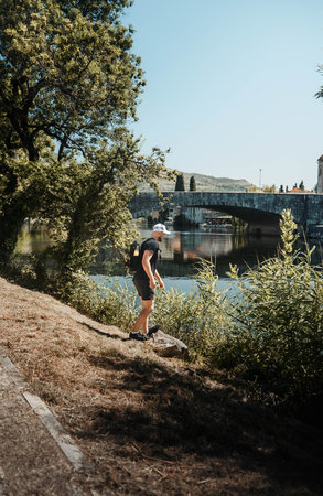Man looking over the Tresbisnjica River in Trebinje, Bosniaの写真素材
