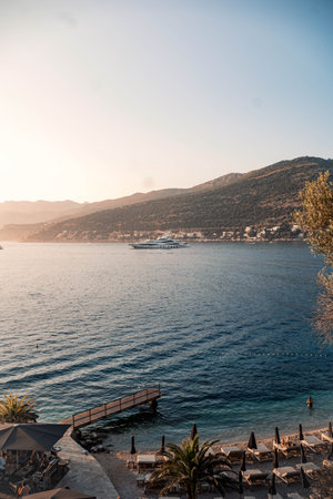 Landscape shot of super yacht in bay at golden hour in Dubrovnik, Croatiaの写真素材