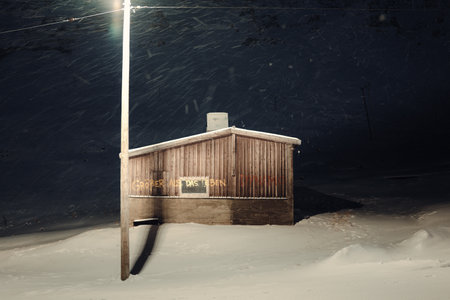 Wooden cabin in the snow in the polar nightの写真素材