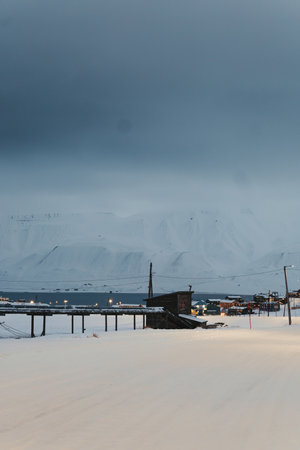 Pipelines in front of snowy fjord in Longyearbyen, Svalbard in the arcticの写真素材