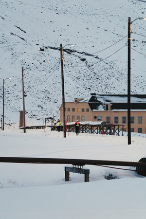 Person jogging along snowy road in Longyearbyen, Svalbardの写真素材