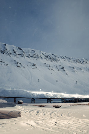 Pipes under snowy mountains in Longyearbyen, Svalbard due to permafrostの写真素材