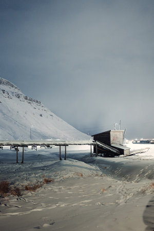 Permafrost pipes above ground into shed in the snow in Longyearbyen, Svalbardの写真素材