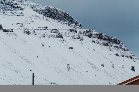 Aerial mining cableway along snowy mountainside in Longyearbyen, Svalbardの写真素材