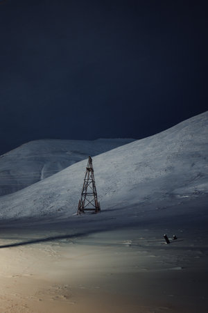 Aerial tramway wooden tower in the snow on mountain in Longyearbyen, Svalbardの写真素材