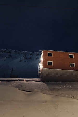 Wooden cabin on snowy arctic mountain in Longyearbyen, Svalbardの写真素材