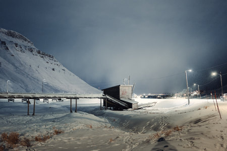 Pipes leading into shed in the snow in Longyearbyen, Svalbard due to permafrostの写真素材