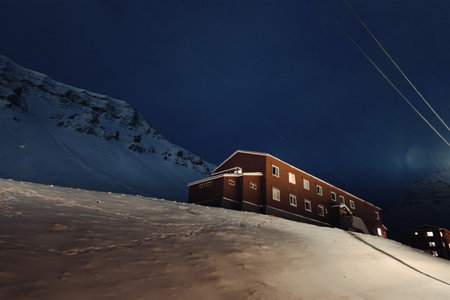 Old wooden miners cabins on snowy hill in Longyearbyen, Svalbardの写真素材