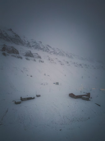 Aerial view of snowy buildings under mountain in Longyearbyen, Svalbard, winterの写真素材