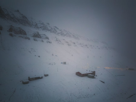 Aerial view of buildings in the snow under mountain in Longyearbyen, Svalbardの写真素材