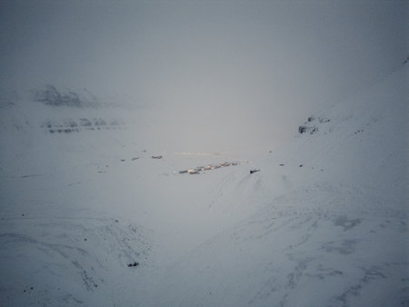 Aerial shot of Longyearbyen, Svalbard from between snowy arctic mountainsの写真素材