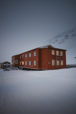 Brown Gjestehuset hostel building in Longyearbyen, Svalbard in the snowの写真素材