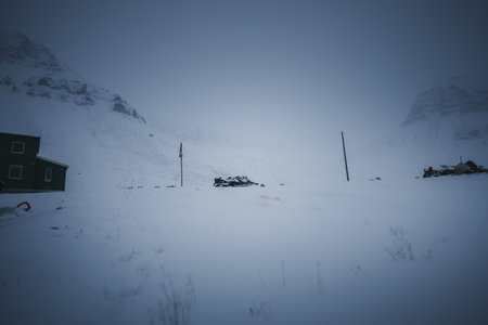 Snowmobiles parked on foggy day in the arctic in Longyearbyen, Svalbardの写真素材