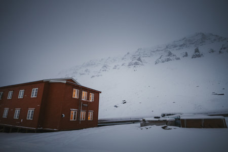 Snowy mountains behind Gjestehuset hostel in Longyearbyen, Svalbard in the fogの写真素材