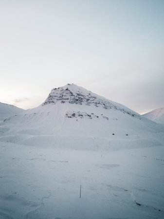 Aerial shot of Sarkofagen mountain at sunset in Longyearbyen, Svalbard in winterの写真素材