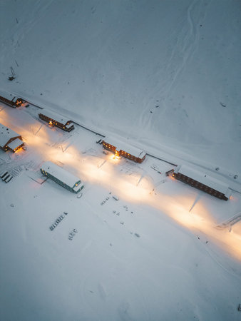 Drone shot of Nybyen in Longyearbyen, Svalbard at sunset in snowy winter
