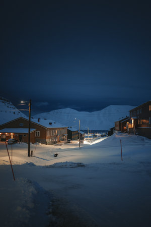 Snowy road view in Longyearbyen, Svalbard in the polar night in winterの写真素材