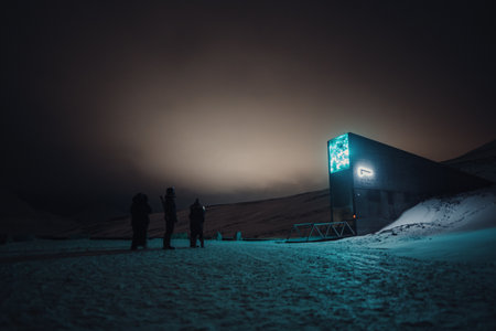 People stood under the light of a building in Longyearbyen, Svalbardの写真素材