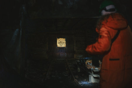 Woman stood looking at wooden doors in coal mine in Longyearbyen, Svalbard