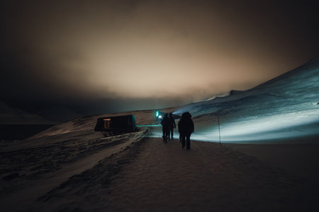 People walking at night in Longyearbyen, Svalbardの写真素材