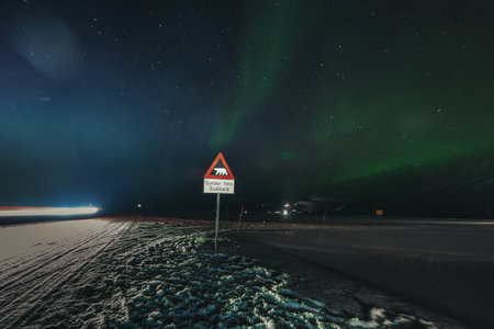 Northern lights over polar bear warning sign in Longyearbyen, Svalbard winterの写真素材