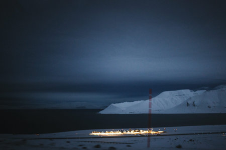 Polar night over fjord and airport lights in Longyearbyen, Svalbardの写真素材