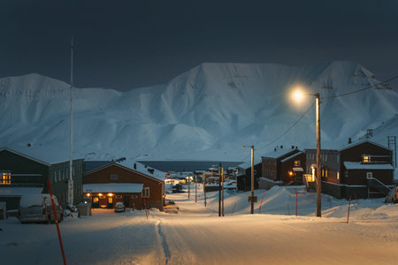 Longyearbyen, Svalbard town in front of snowy fjord in the polar night, winter