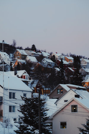 Snowy colourful houses on hill in Tromso, Norway in winterの写真素材
