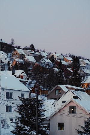Colourful houses on snowy hillside in winter in Tromso, Norwayの写真素材