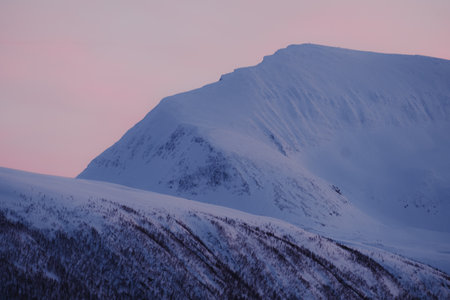 Tromsdalstinden mountain peak against pink dusk sky in Tromso, Norwayの写真素材