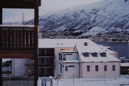 Buildings in the center of Tromso, Norway in snowy winter at sunsetの写真素材